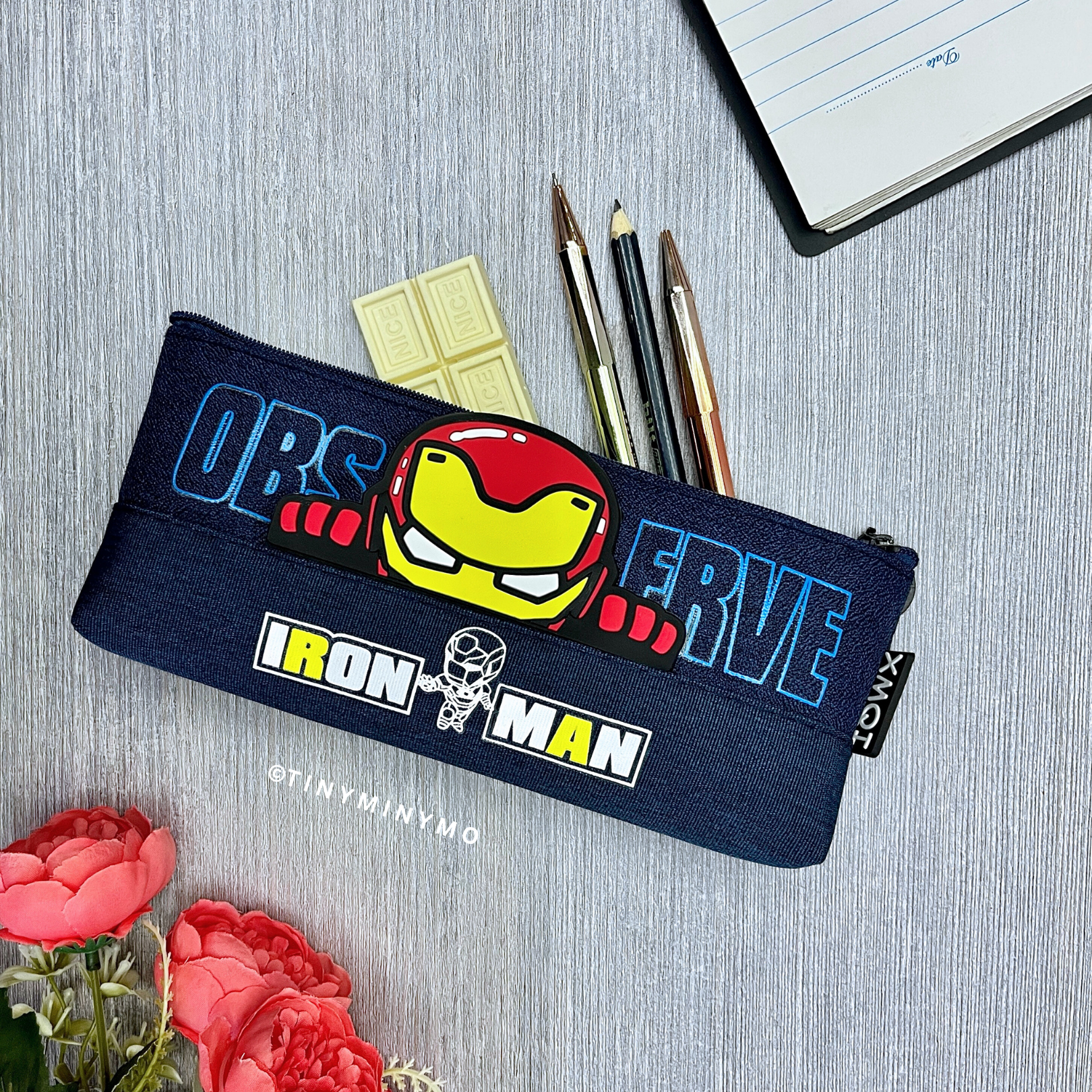 Superhero Pencil Pouch Featuring Iron Man Design, Placed on a Grey Surface with Stationery Items and a Flowers - Tinyminymo
