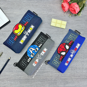 Three Superhero Pencil Pouches with Superhero Designs, Placed on a Grey Surface Alongside a Flowers and a Chocolate Eraser - Tinyminymo