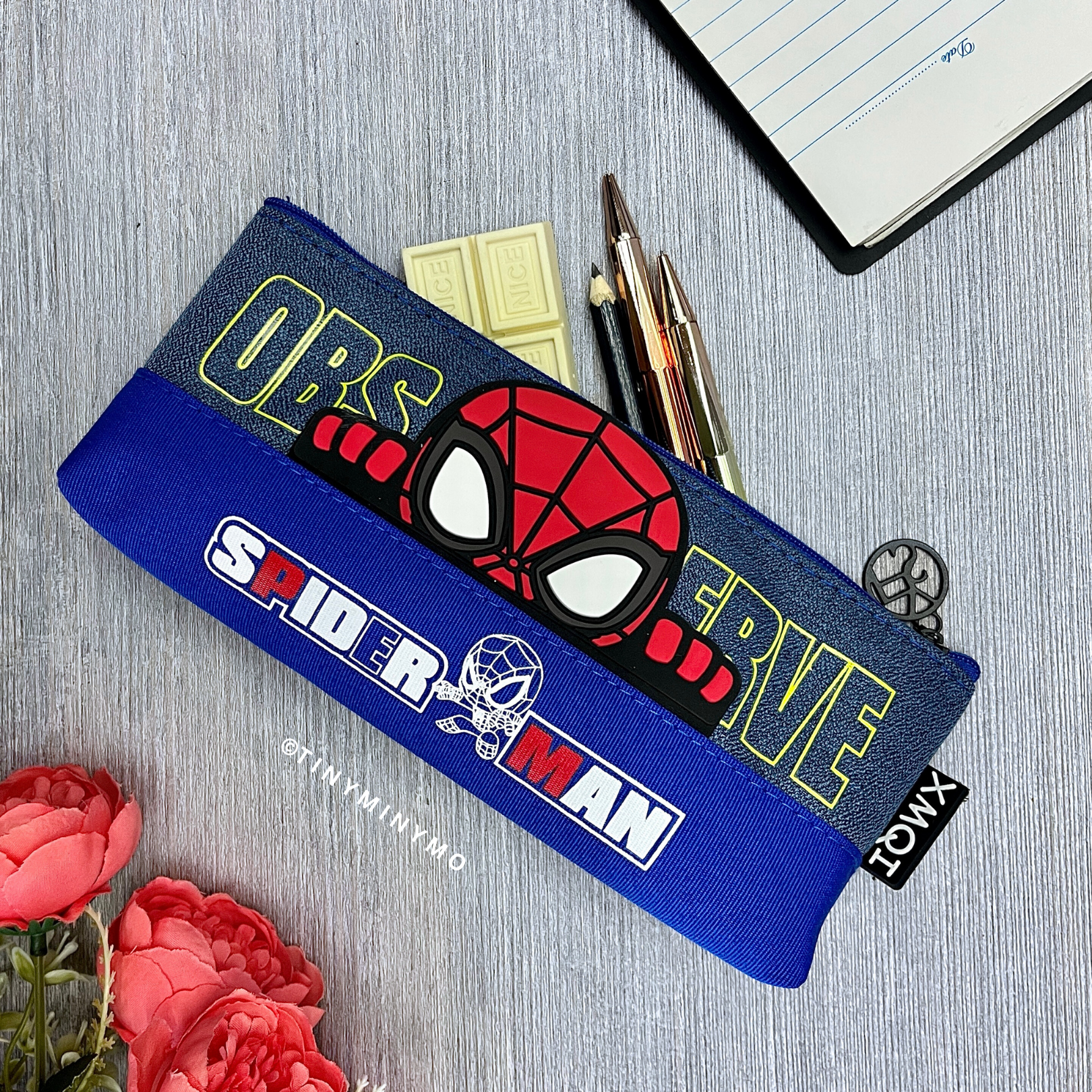 Superhero Pencil Pouch on a Grey Surface with Flowers and Stationery Items - Tinyminymo